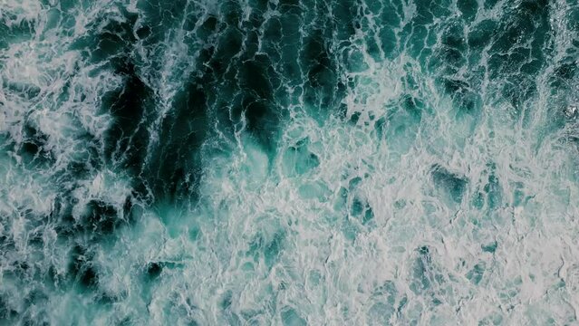 Huge waves crash on the reef. Beautiful texture of water and foam. Aerial view