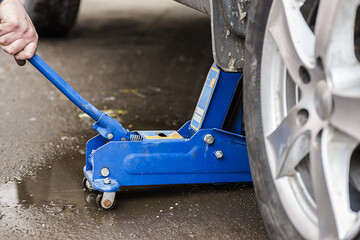 Changing car wheel with hand jack