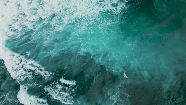 Huge waves crash on the reef. Beautiful texture of water and foam. Aerial view