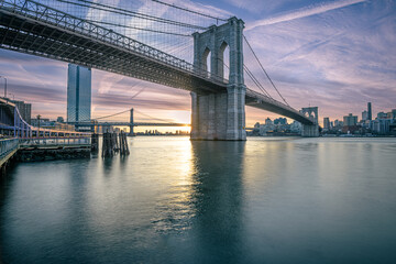 Fototapeta na wymiar Brooklyn Bridge at Sunrise with Brooklyn skyline in the background