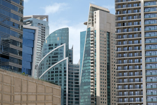 Futuristic and modern commercial and residential highrise tower skyscraper architecture with glass facades and clean lines in downtown Dubai, United Arab Emirates for millionaires and high society