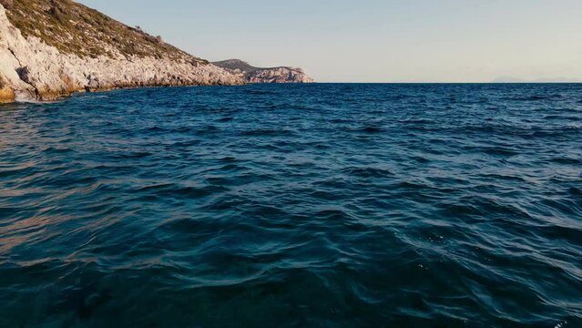 Aerial shot flying above sea water alonge rocky coastline Aegean sea in Datca peninsula in Turkey