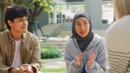 Small Asian group of people sit in a close circle and talk to a therapist in park. Smile people...