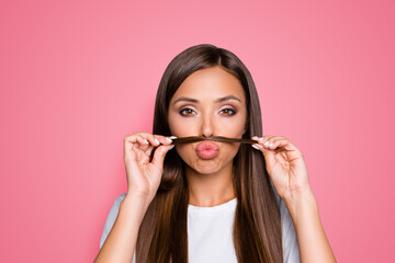 Photo of nice adorable girl make jokes fake mustache with hair curl isolated pastel color...