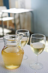 Portuguese Vinho Verde (green wine ) in jug and wine glasses on a restaurant terrace in Lisbon