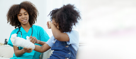 African - American black little girl have an accident at her right arm and see the doctor in hospital.