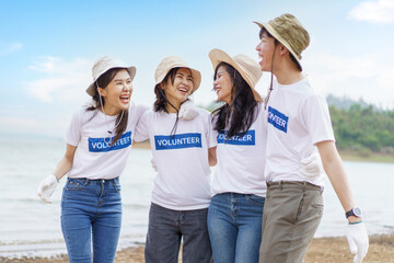 Group of Asian young people volunteer helping to collecting or picking up a plastic bottle garbage...