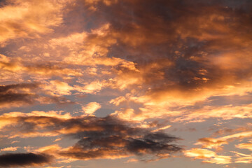 Obraz premium Orange sunset sky. Beautiful sky landscape with spectacular clouds. Wallpaper photo.