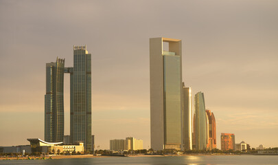 Sunset over Abu Dhabi. Landscape with skyline and skyscraper modern buildings of Abu Dhabi during a beautiful sunset. Travel to United Arab Emirates, 2023.