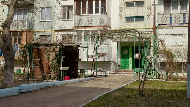 Poverty in post soviet block of flats and shot of entrance in the building. Soviet architecture district with apartments.