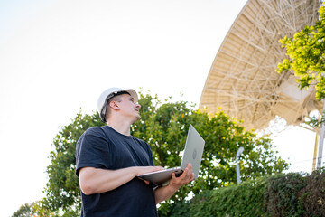 Engineer looking earth based astronomical radio telescope