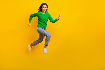 Full length photo of overjoyed cheerful person jumping rush empty space isolated on yellow color background