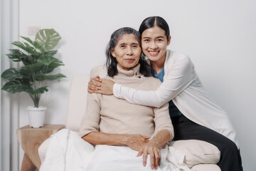 Elderly mother with young daughter asia people only woman sitting on sofa at home have fun enjoying weekend together.