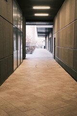 Long tunnel with mirrors in modern city architecture with low lights and grey colors with tile on the frloor