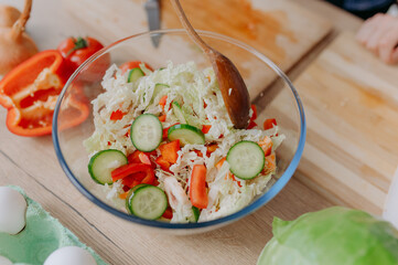 Close-up of a vegetable salad. mix the ingredients of the superfood salad with spoons in the...