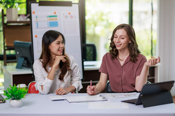 Concept of business office woman working,Businesswoman smile while working about her invesment plan with analyzing document and business investment graph data by using laptop on desk in workstation.