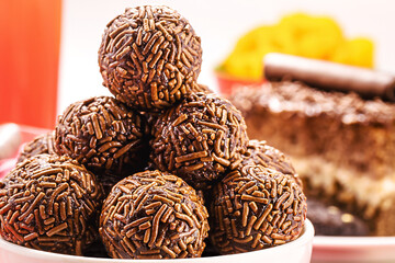 Brazilian chocolate bonbon, called Brigadeiro, made with condensed milk, chocolate powder and sprinkles, served with cake at birthday parties , macro photography