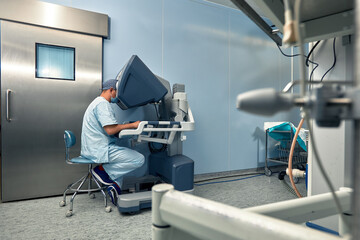 Hands of a surgeon at a computer robot. medical robot. Robotic Surgery.