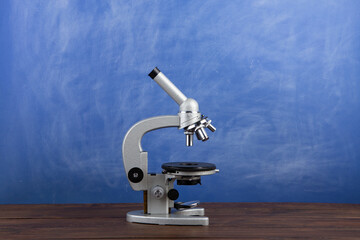 Back to school - microscope on the desk, Education concept. Blackboard background