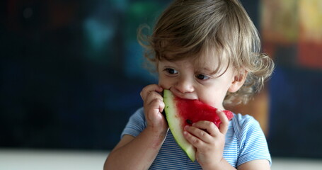 Toddler boy eating watermelon, eats fruit snack