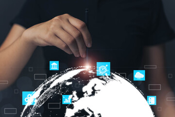 Businessman is pointing at the globe with a pen. Audience targeting concept with internet technology that collects large data of all over the world.