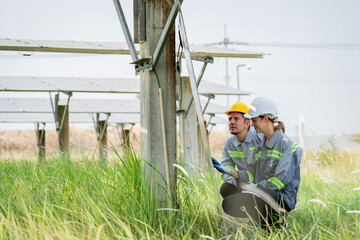 Electrical engineer on solar farm with large structure Check maintain rehearse damaged parts from use in order to produce electricity with maximum efficiency throughout its service life professionally