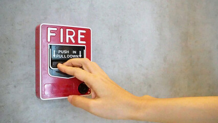 Fire alarm notifier or alert or bell warning equipment and hand use when on fire.