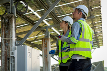 Electrical engineer on solar farm with large structure Check maintain rehearse damaged parts from use in order to produce electricity with maximum efficiency throughout its service life professionally