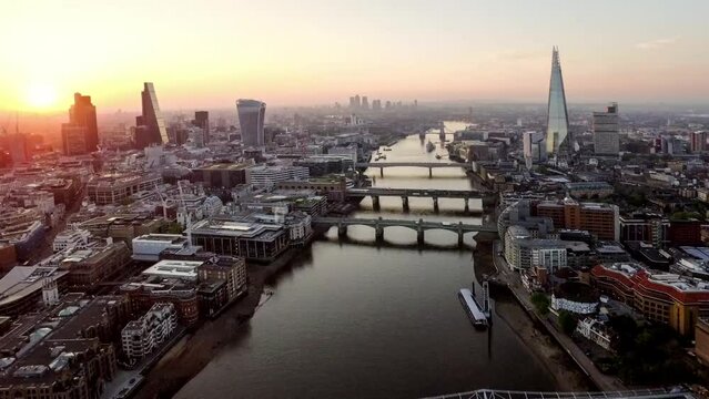slow helicopter flyover London and the river Thames at sunrise