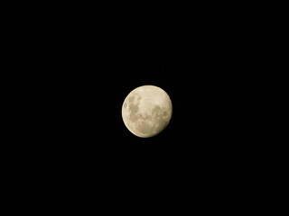 Photo of the full Moon on the 4rd of April 2023, that is a Waxing Gibbous moon phase, against a pitch black night sky. The moon is more than 50% illuminated but has not yet reached 100% illumination
