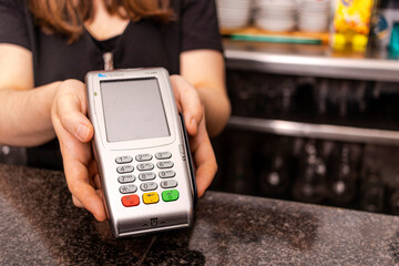 Waitress brings you the dataphone for payment