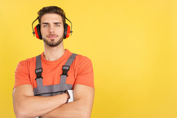 Serious worker standing with arms crossed looking at camera