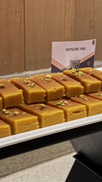 Closeup of famous sweet mysore pak and badushah on display plates