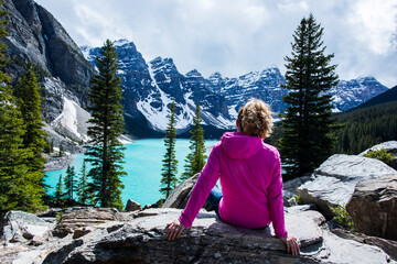 Naklejka premium Young woman in Moraine lake, Banff National Park, Canada