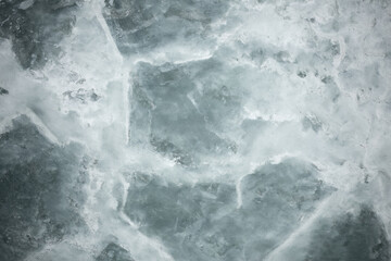 Gray background of decorative plaster with abstract spots. Unusual silver wall texture with beautiful patterns, creative surface background. Dressing coating for building cladding.