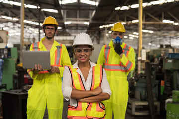 Group of male and female factory worker working in industrial factory. Team of technician inspecting quality in manufacturing process lines. Male and female engineer in workshop