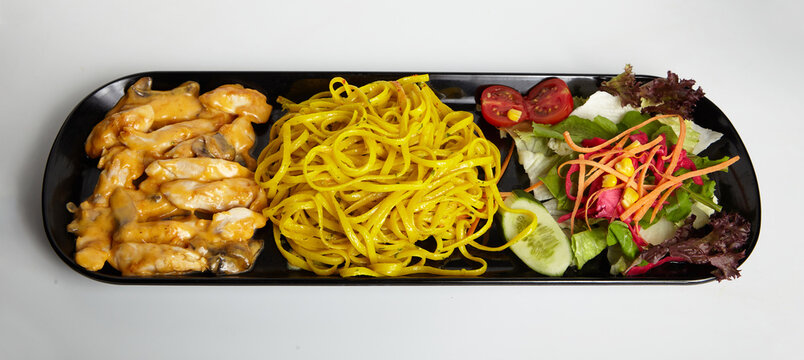 Grilled Chicken With Cheddar Sauce and Linguine Pasta with Green Salad White Background