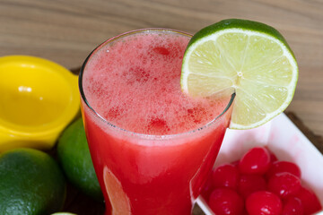 Cherry lemonade in crystal glass on brown wooden table