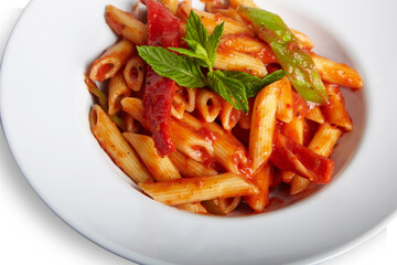 Penne Arrabbiata Pasta With Tomato Sauce on White Plate Isolated White Background Close Up