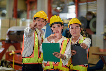 Factory apprenticeship. Header mentor teaching young employees trainee operating machine looking monitor and check Production process machinery. foreman explaining team engineer control machine
