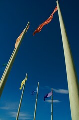 multi colored flags on tall poles Oxnard beach California
