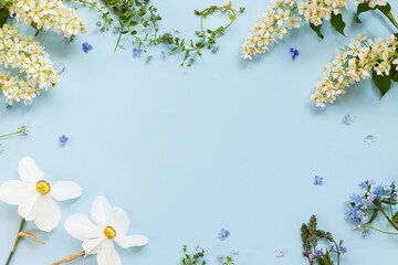 Spring flowers flat lay on blue background. Floral card template with space for text. Happy easter!...