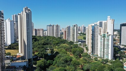 Fototapeta na wymiar Wonderful panoramic view of Flamboyant Park with lakes and tropical trees surrounded by modern residential apartments in Goiania, Goias, Brazil in April, 2023. 