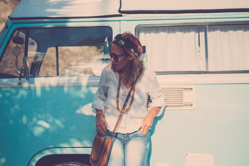 One woman against blue classic van travel and enjoy hippy lifestyle leisure outdoor activity alone....