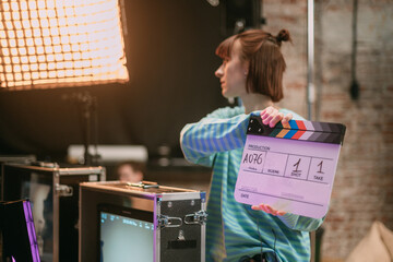 Assistant director with clapperboard on set. Close-up of firecrackers for filming a movie,...