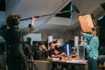 Film set, monitors and modern shooting equipment. Film crew, lighting devices, monitors, playbacks - filming equipment and a team