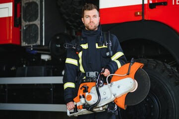 Firefighter portrait on duty. Photo fireman with gas mask and helmet near fire engine.