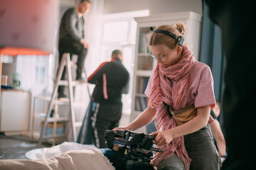 Director at work on the set. The director works with a group or with a playback while filming a...