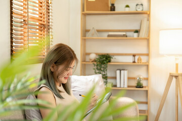 Attractive young woman fashion designer standing and working in studio