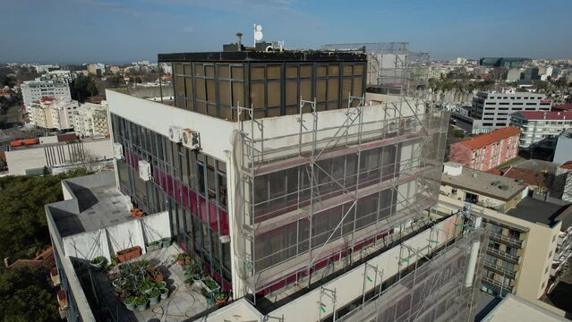 A scaffolding around the facade during renovation. Drone aerial